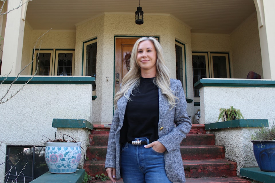 Jennifer Travelbea standing outside of the family-home on the 960 Foul Bay Rd. lot.