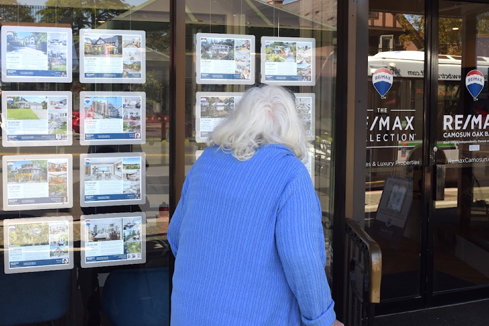 A local walks past Remax Camosun on Oak Bay Avenue.