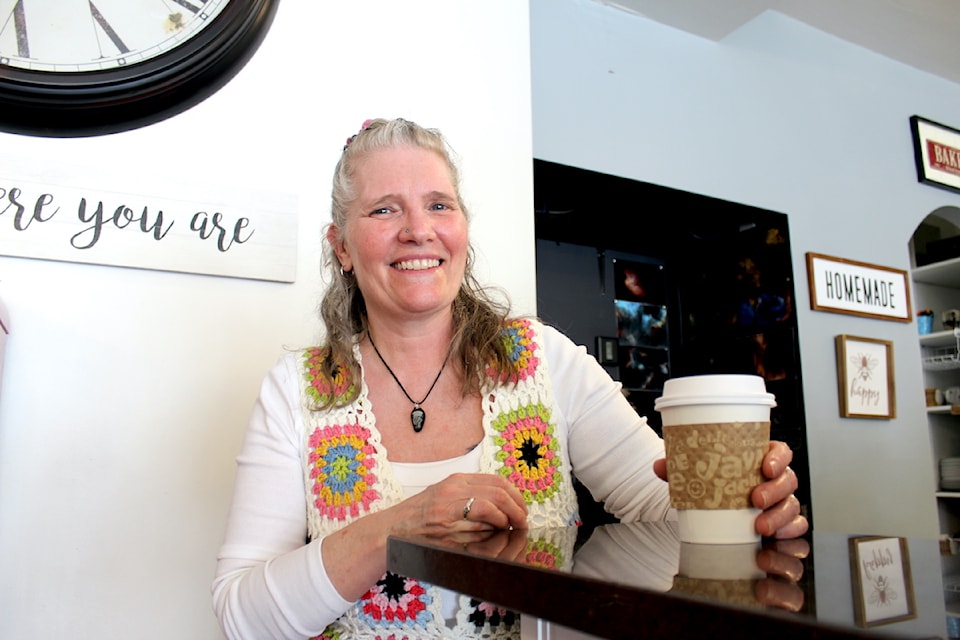 Co-owner Sam Marsman serving a latte on The Allenby's final day in business.