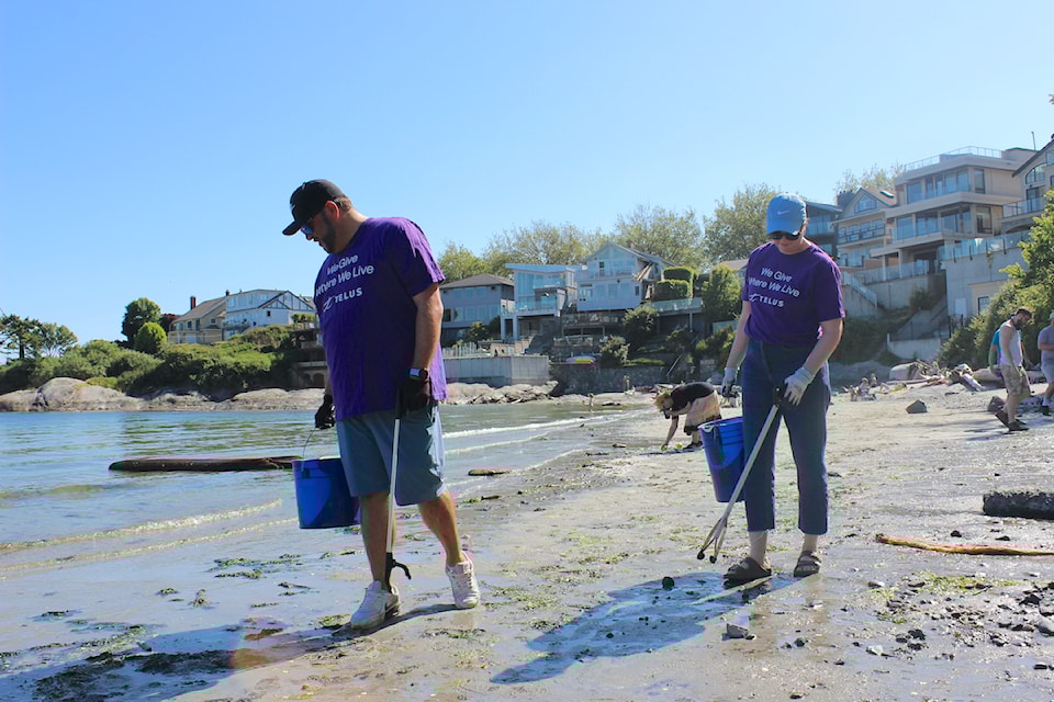 Volunteers Adam Horvath and Melanie Johnson-Jagiello collect trash on Gonzales Beach.