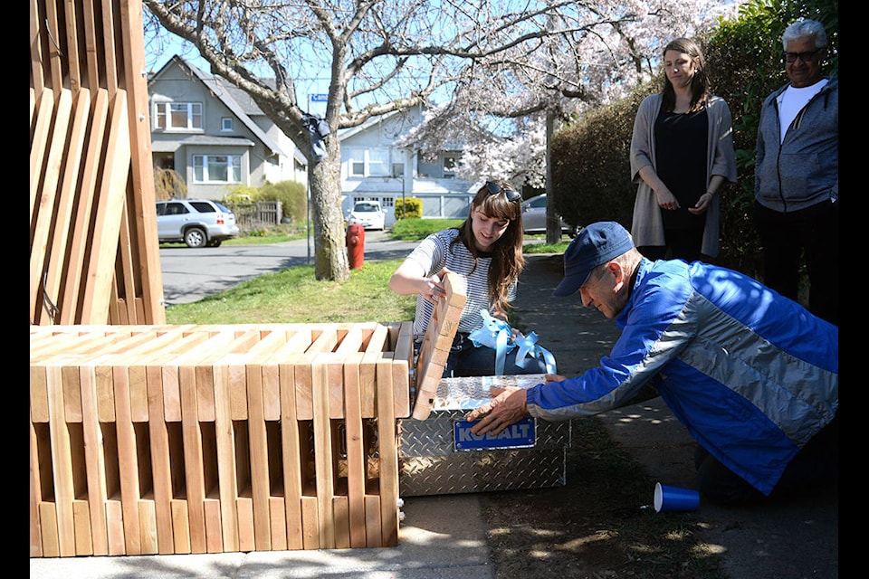 Neighbour Lab creative director Emi Webb and local resident Bob McKechnie reveal the secure, passcode protected box of emergency supplies inside the new Leonard Street Neighbour Hub. (Nina Grossman/News Staff)