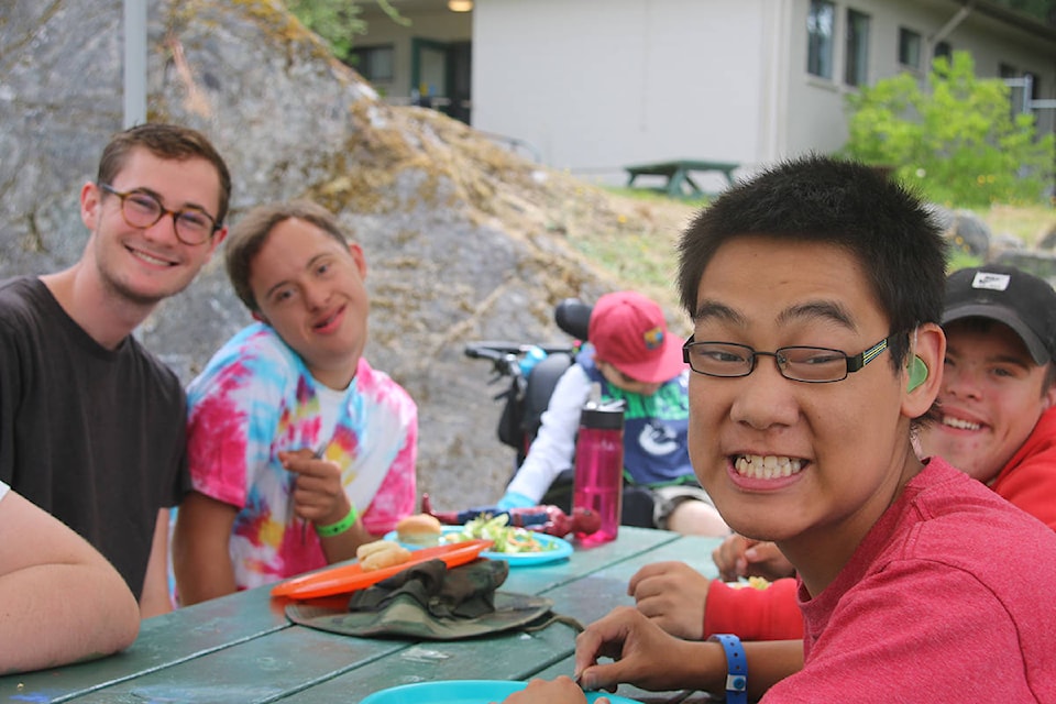 Elliott Cordingley (far left), a camp counsellor shares a laugh with Samuel Layton (left), Jacob Robbins (far right) and Drake Diehl (middle right) at Easter Seals Camp Shawnigan. (Kendra Crighton/News Staff)