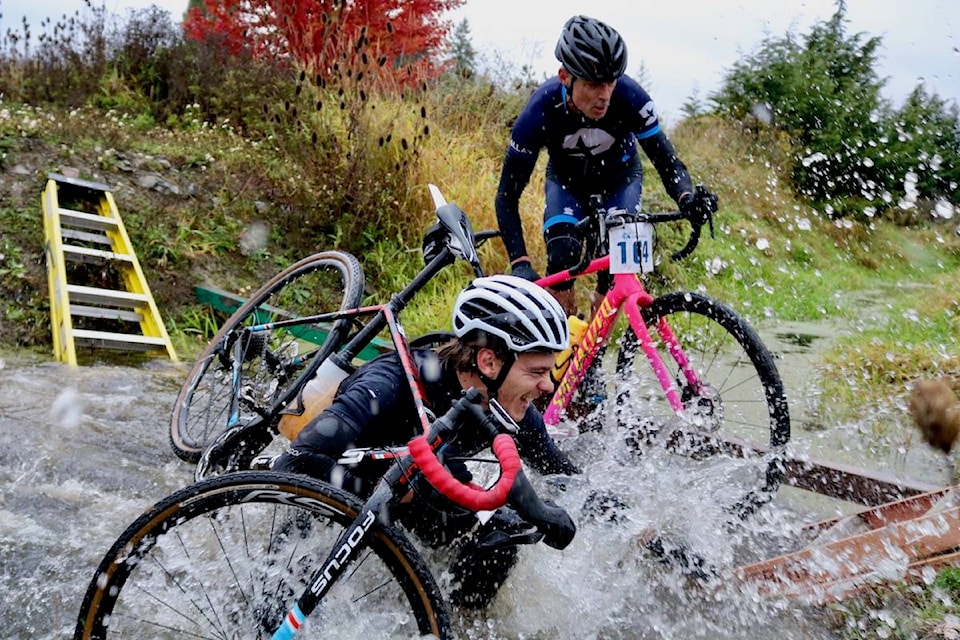 A biker gets wetter than expected while crossing a water-filled ditch during the Tripleshot Crossfondo race on Oct. 20. (Aaron Guillen/News Staff)