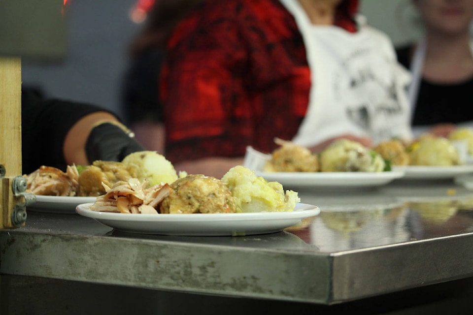 About 800 of Greater Victoria’s homeless and most vulnerable were served up a full Christmas meal at Our Place on Tuesday afternoon. Volunteers, local politicians, community members and staff came together to help serve the community. (Shalu Mehta/News Staff)