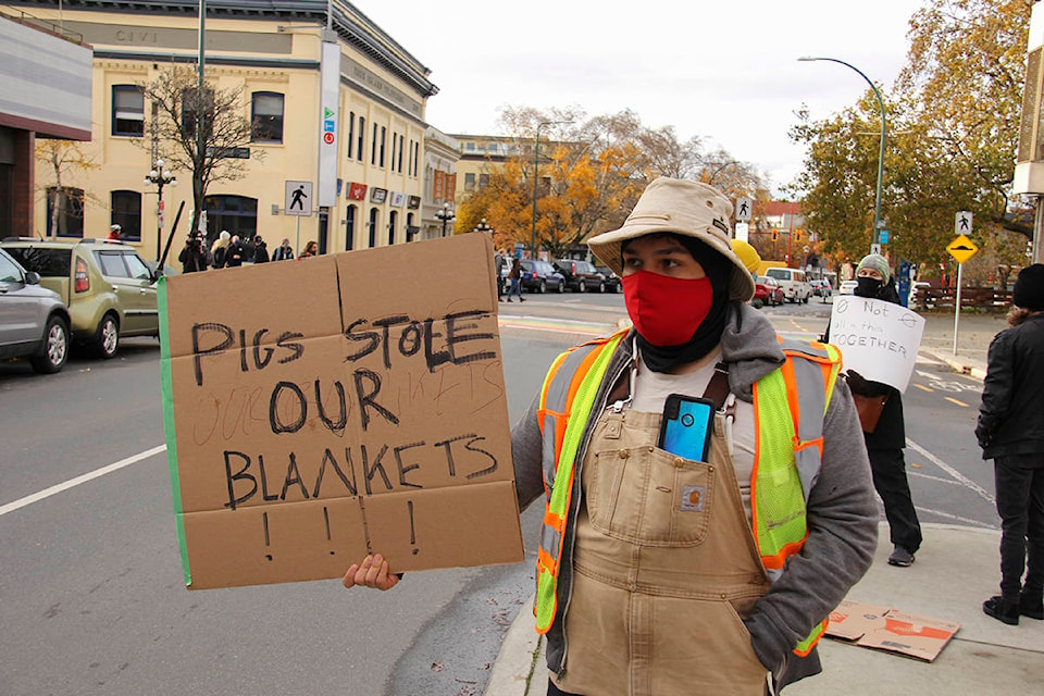 Over 20 people gathered outside City Hall Friday afternoon to protest the City’s removal of a community tent and showers from Beacon Hill Park. (Jane Skrypnek/News Staff)