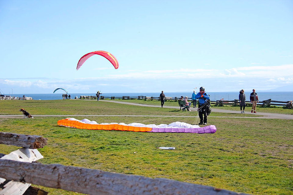 Paragliders worked to capture a big enough gust to get them flying near Clover Point Saturday. (Jane Skrypnek/News Staff)