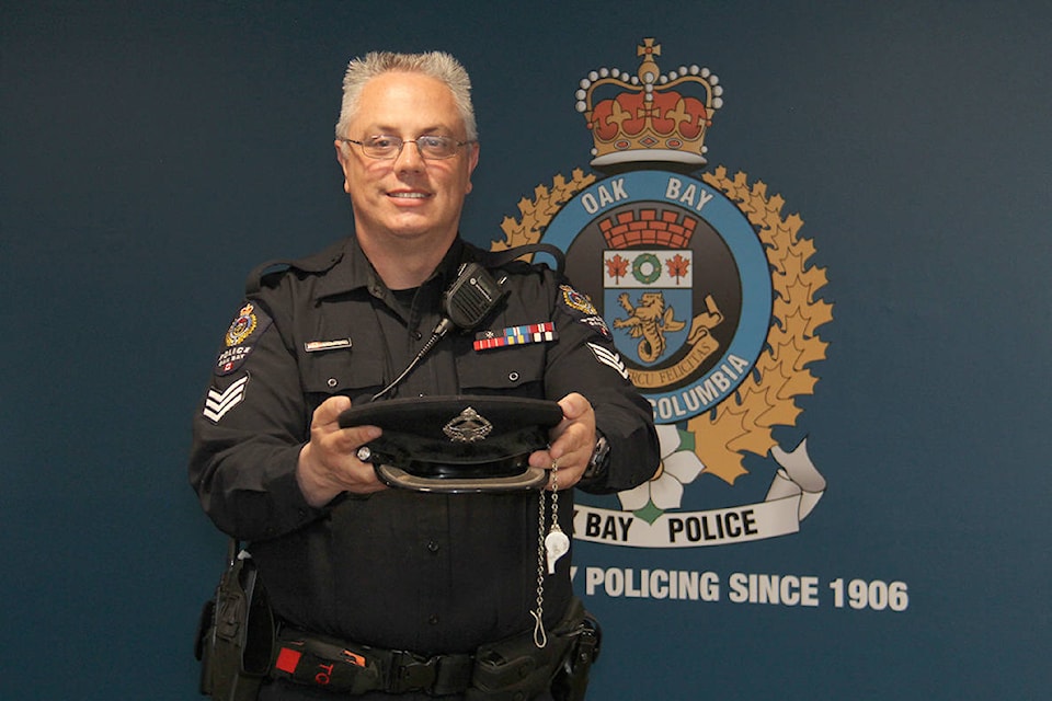 Oak Bay police Sgt. Manny Montero with a selection of historical department items he’s collected in his nearly four years with the department. (Christine van Reeuwyk/News Staff)