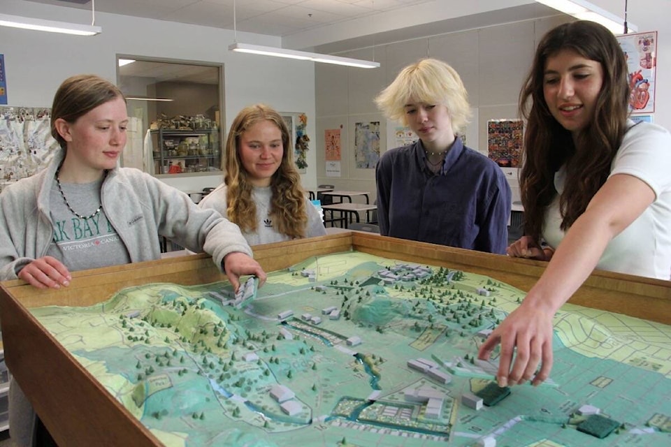 Grade 12 students Shona Sinclair (left), Katie Bentley, Sophia Taylor and Olivia Friesen, first saw the original model in Grade 9. Now they enjoy the benefits of the new model in their Oak Bay High classroom. (Christine van Reeuwyk/News Staff)