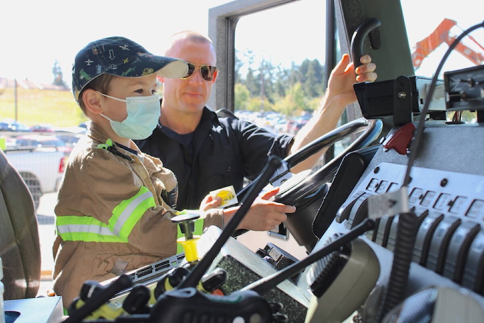 Kyrie Parimi, 5, gets a turn in the driver seat of a Victoria firetruck when crews from local departments visited children at Victoria General Hospital on July 20. (Jake Romphf/News Staff)