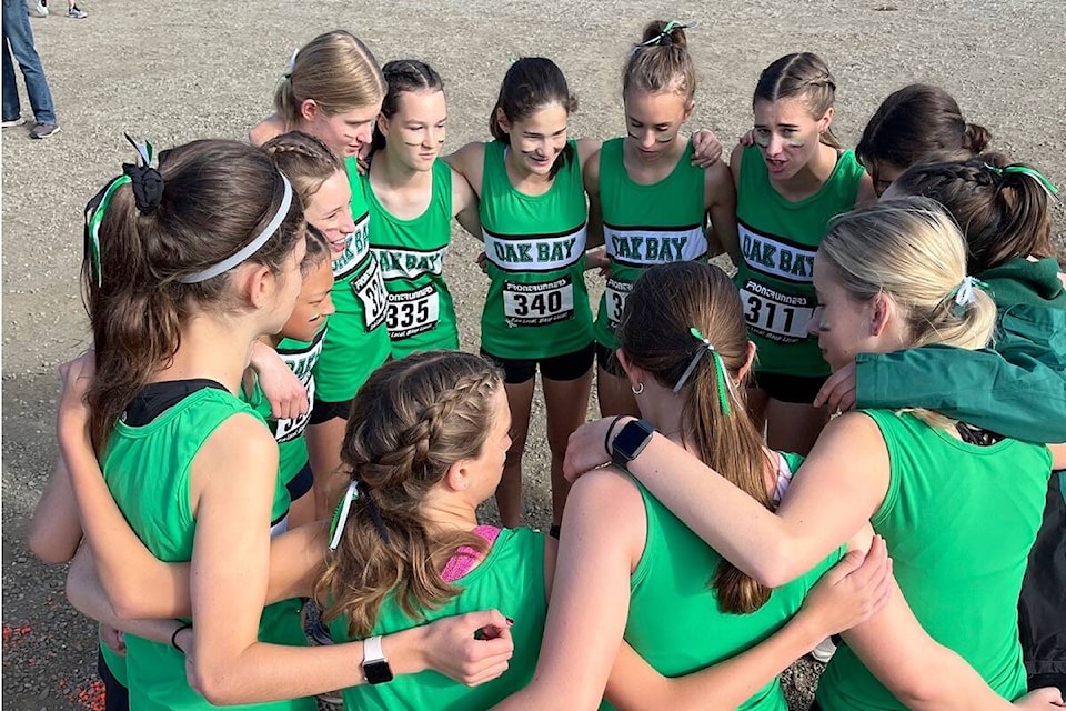 The Oak Bay High Junior girls cross-country team huddles while the senior girls lead the pre-game pep talk ahead of the Island competition in Port Alberni. (Courtesy Oak Bay High)