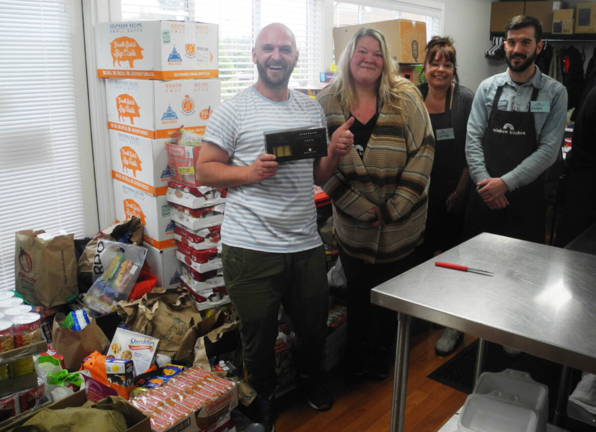 The Rainbow Kitchen team receives the donations from the 2022 Realtor Food Bank Challenge in Oak Bay. Oak Bay BIA photo