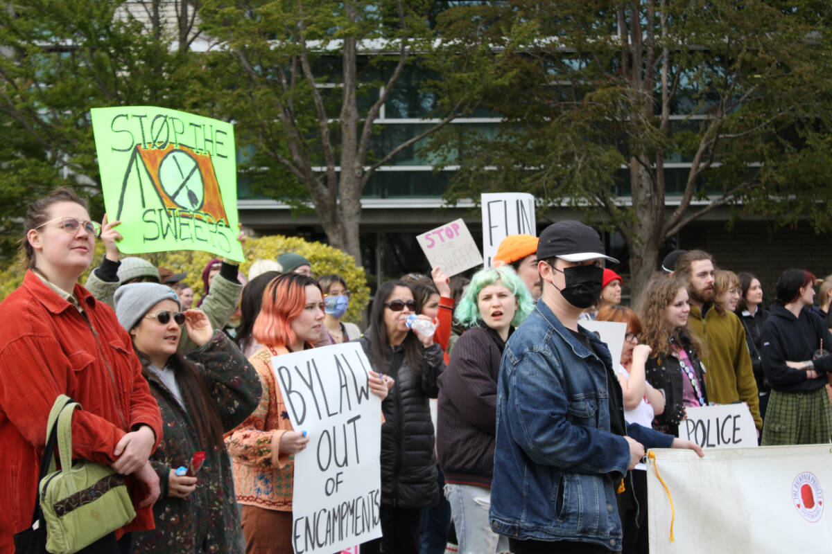 Members of the group hold signs. (Hollie Ferguson/News Staff)