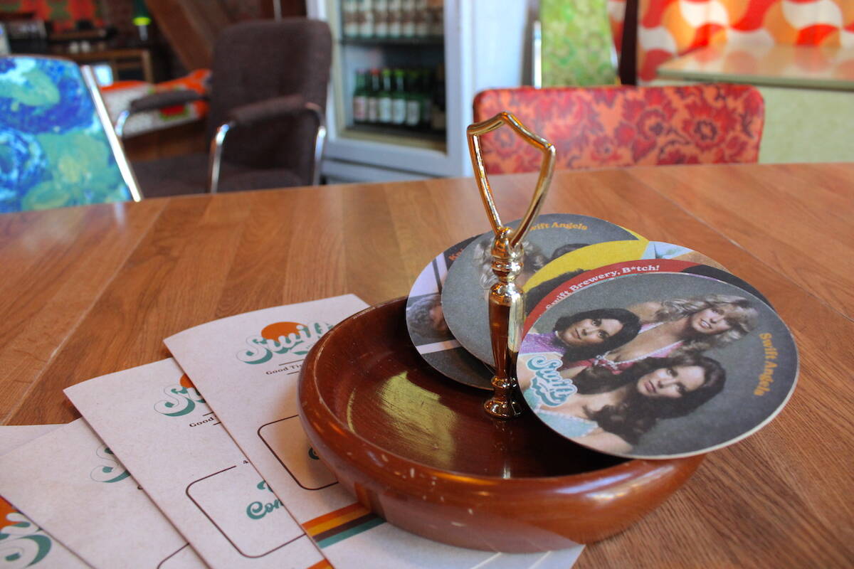 Coasters featuring some throwback pop-culture icons at Swift Brewery. (Jake Romphf/News Staff)