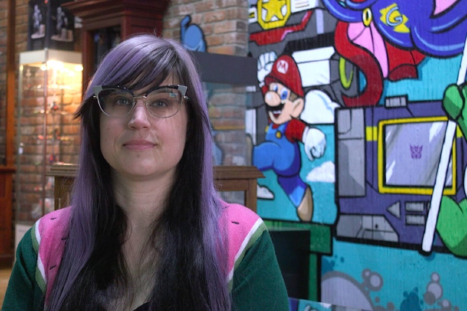 Co-owner of Cherry Bomb Toys, Candice Woodward, in front of newly painted mural in her toy store. (Ella Matte/News Staff)
