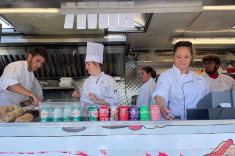 Students at Mount Doug secondary line up for lunch at the Camosun Cuisine Machine, where both college and high school students can experience the high-paced environment on a food truck. (Stephanie Dawson/Courtesy SD61)