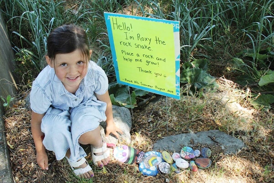 Rosie Holoiday, 6, hopes her community will come through, growing Roxy the rock snake with colourful painted stones. The project sits close to the walking path from Bowker Road and Willows Beach. (Christine van Reeuwyk/News Staff)
