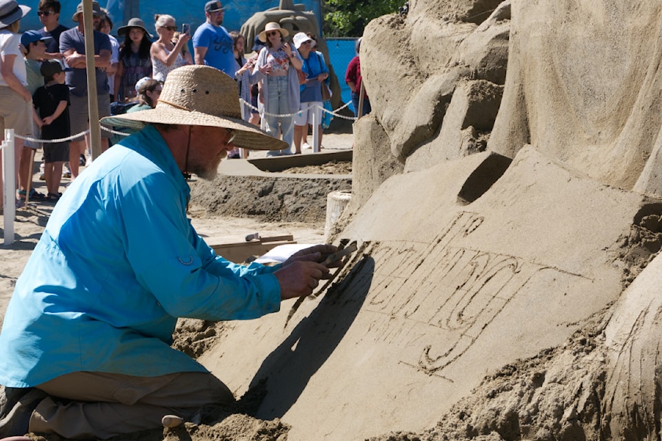 Canadian Fred Dobbs works on his sculpture in the Quality Foods Sand Sculpting Competition in Parksville on July 14.