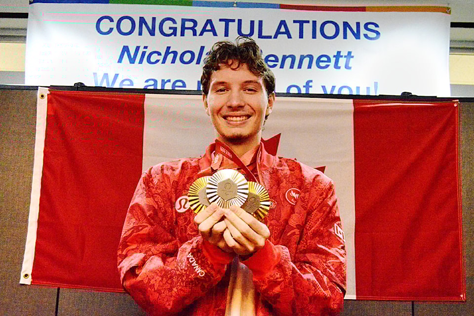 Parksville Paralympian Nicholas Bennett shows supporters the medals he won at the 2024 Paralympic Games in Paris. (Michael Briones photo)
