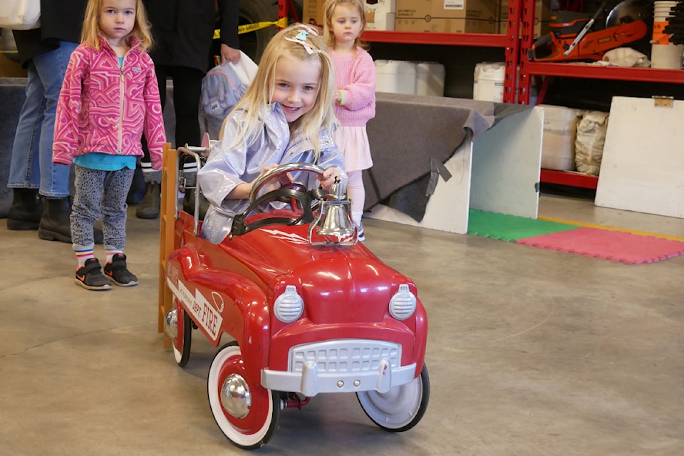 Lina Uzdavinys rides in a mini fire truck on Oct. 27 during the Parksville Fire Rescue Annual Open House.