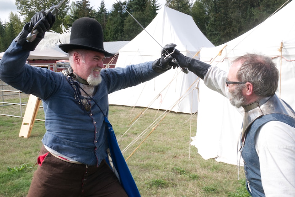 Nathan Brown, also known as Master Connal (left) and James Allan, also known as Lord Seamus, recreate rapier fighting at the Medieval Faire by the Shire of Hartwood branch of the Society for Creative Anachronism on Sept. 15 in Coombs.  