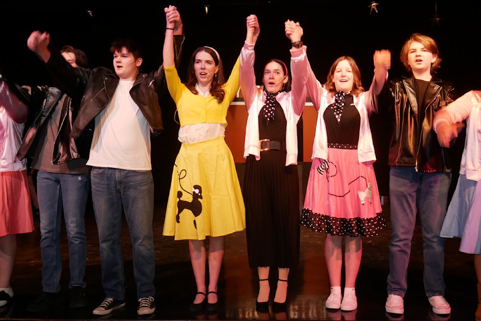 Ethan Liedl (left) as Danny Zuko, Lena Janeski (second from left) as Sandy Olsson with the rest of the 'Grease' cast.