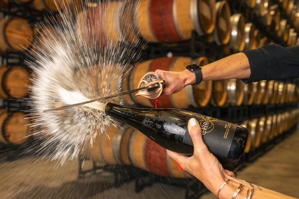 sabering-a-bottle-of-sparkling-wine-courtesy-of-chronos-winery-penticton-downtown