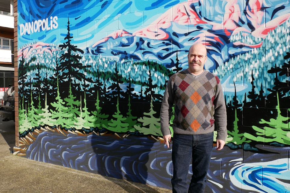 Kevin Kinnear, owner of Parks West, with a mural he commissioned by spray paint artist Danopolis.