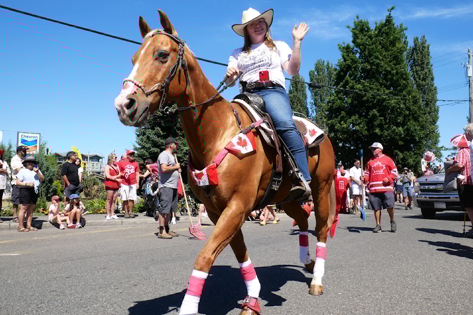 Josie Jennett and her horse Jimmy take part in the Parksville Canada Day Parade with the Silver Spur Riding Club .