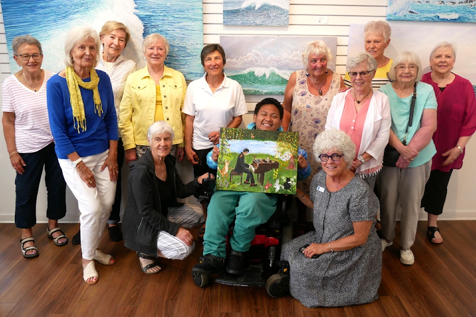 The DeCosmos Fine Arts Society surprised Red (centre) with their best artistic representation of a dream he described to the group who paint at the MAC in Parksville.
