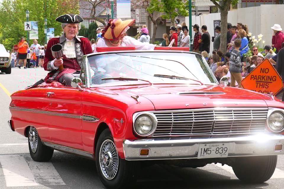 Qualicum Beach town crier Len Mustard and wife Marie lead the Qualicum Beach Family Day Parade on May 25.