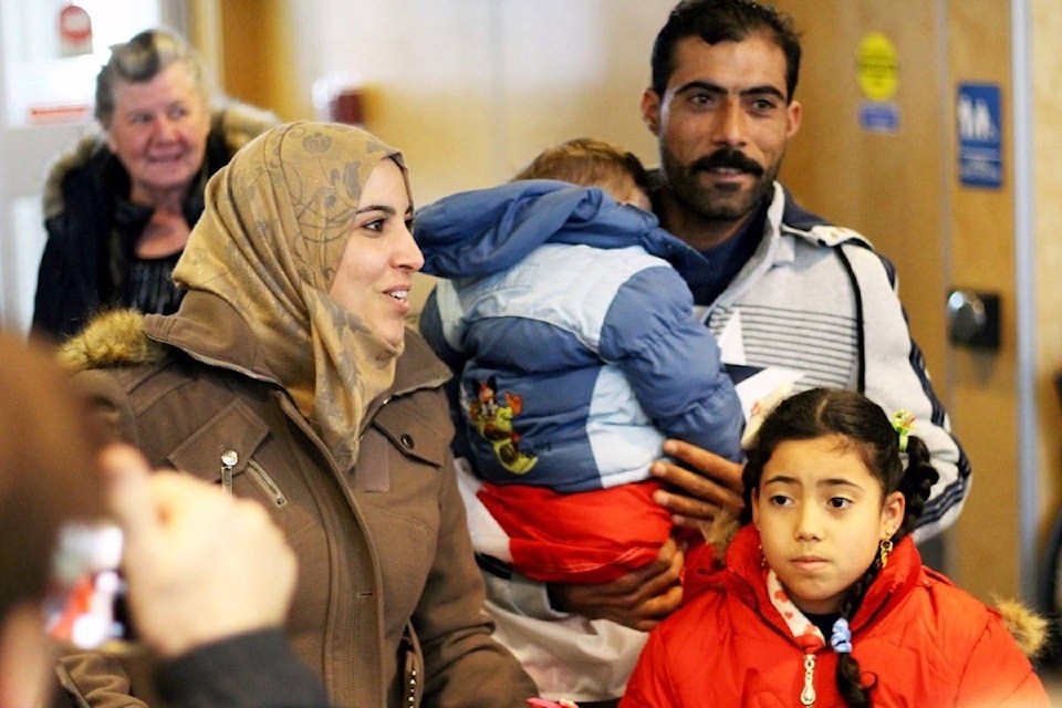 9942693_web1_171222-PQN-M-RefugeeFamily-arrival1-lc-dec22