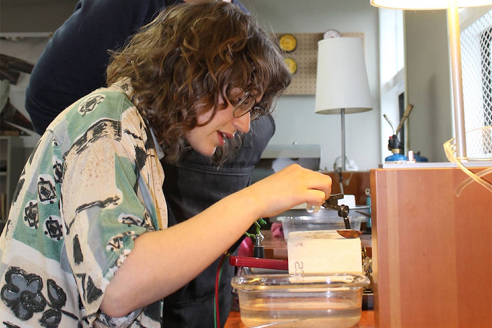 Emily Vance, feeling like an alchemist as she prepares to anneal the sterling silver ring shape with a torch. (Francois Lavigne photo)