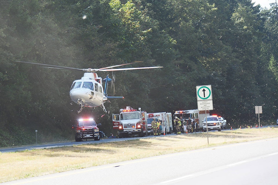 An air ambulance prepares to land on the highway near Parksville after an auto accident on Monday, Aug. 17, 2020. (Peter McCully photo)