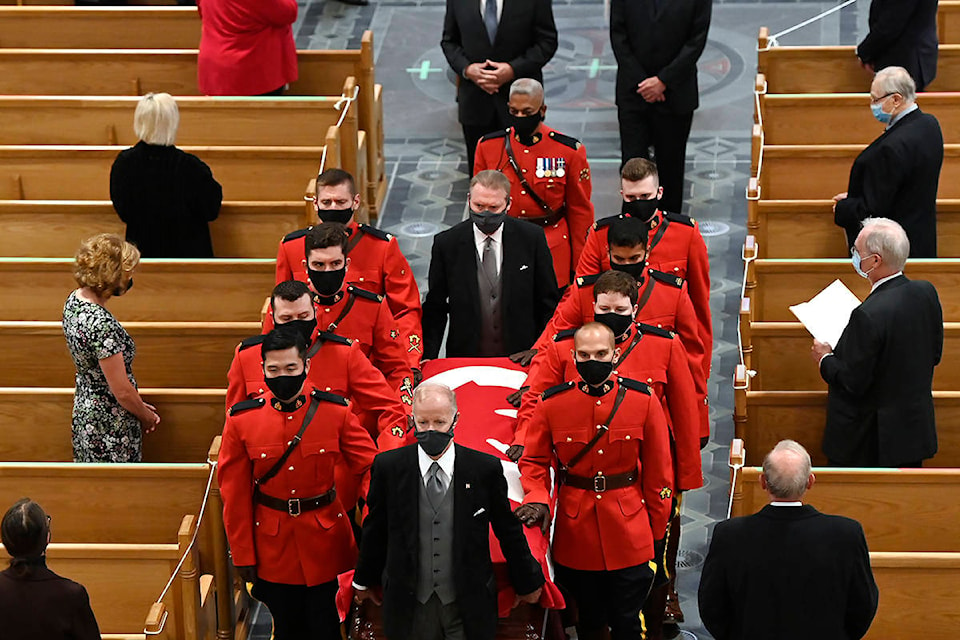 Members of the Royal Canadian Mounted Police carry the casket of former Canadian prime minister John Turner out of St. Michael’s Cathedral Basilica during his state funeral service for in Toronto on Tuesday, October 6, 2020. THE CANADIAN PRESS/Nathan Denette