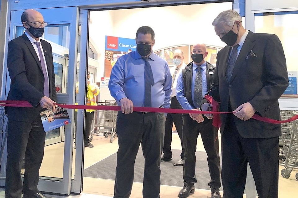 Parksville Mayor Ed Mayne, right, cuts the ribbon to officially open the new Quality Foods store March 24, 2021 with QF president Noel Hayward, left, and store manager Darcy Ginter. (Michael Briones photo)