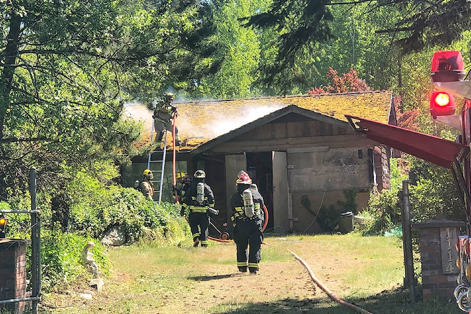 Firefighters are on scene at Dobler Road as they extinguish a house fire on May 19, 2021. (Michael Briones photo)