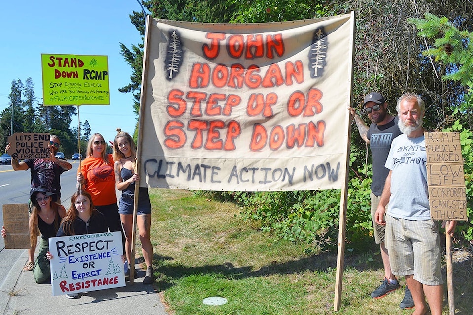 Protesters supporting the Fairy Creek old-growth logging blockade and calling for RCMP enforcement to stand down at the site were gathered outside the Oceanside RCMP detachment on Pym Street in Parksville, Monday, Aug. 23, 2021. (Mandy Moraes photo)