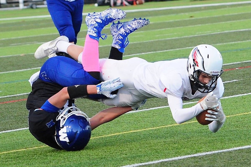 Ballenas Whalers defensive back Kyle Kearns makes a tackle on a Carson Graham Eagles player. (Michael Briones photo)