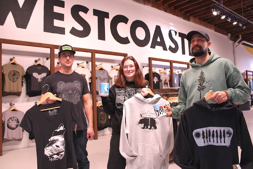 Westcoastees employees show off some of the Vancouver Island-based and inspired clothing company’s merch at the Store Street location. (Jake Romphf/News Staff)