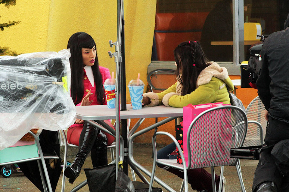 Cast members in an upcoming series called Reginald the Vampire on set at the ‘Slushy Shack,’ a transformed gas station at the intersection of Glanford Road and Vanalman Avenue in Saanich. (Megan Atkins-Baker/News Staff)