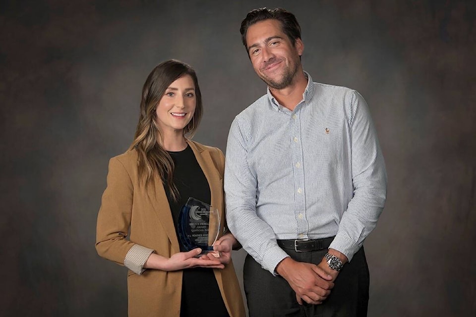 Chelsea Mardon accepts the award, on behalf of Heather Ritchie of Oceanside Neighbourhood Welcome, for Service Excellence Qualicum Beach from Justin Schley of Quality Foods. (HA Photography)