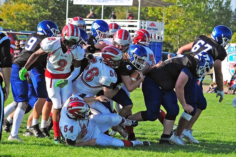 Ballenas Whalers quarterback Mark Filko muscles his way through the John Barsby Bulldogs defence to score a two-yard touchdown. (Michael Briones photo)