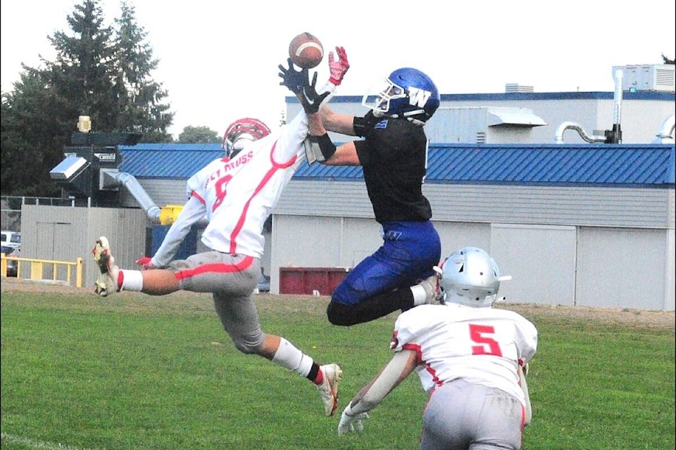 Ballenas Whalers player Rohan Barlow tries to grab the ball under pressure from Holy Cross Crusaders losing a touchdown opportunity. (Michael Briones photo)