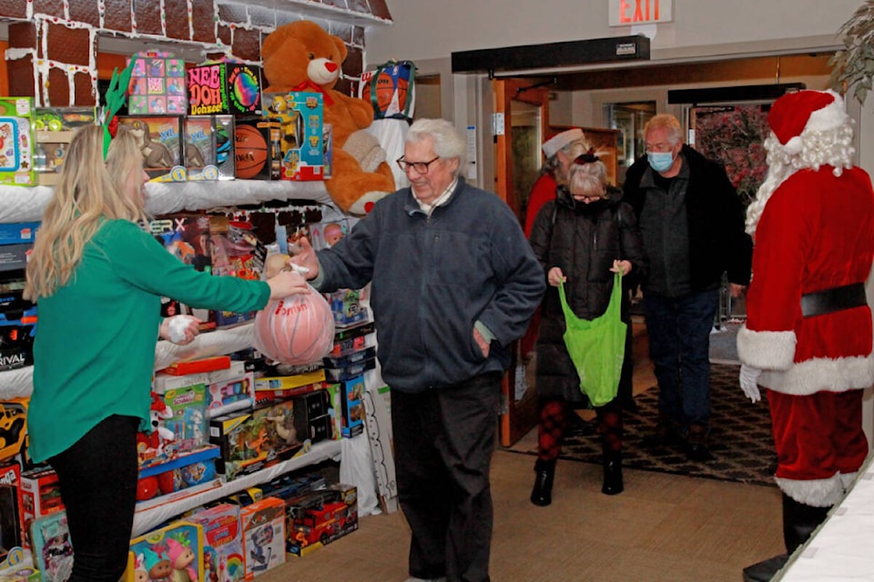 Donors drop off gifts at the Tigh-Na-Mara Toy Drive, benefitting the SOS Caring for Community at Christmas program. The gifts will fill the SOS Toy Shop, where parents and grandparents in need will shop for free for their children. (Lissa Alexander photo)
