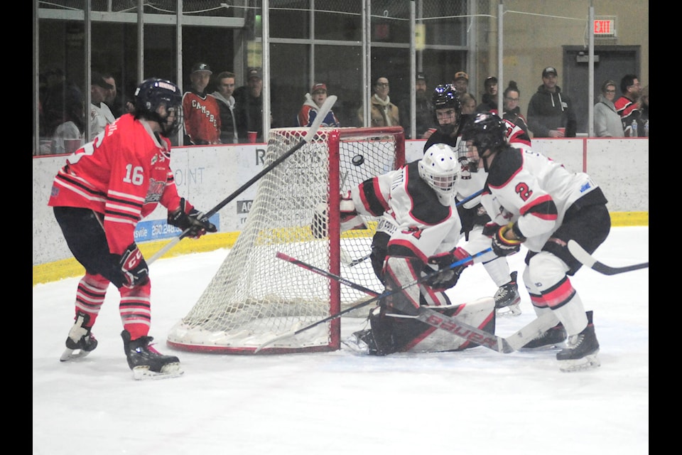 Oceanside Generals top scorer Carter Johnson tips the puck into the net, beating Port Alberni Bombers goalie Lukas Toth. (Michael Briones photo)