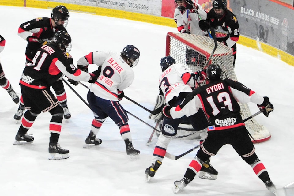 Oceanside Generals Brady Van Herk keeps jabbing the puck against Campbell River Storm’s Nick Peters that eventually went in to win 3-2 Game 3 of the VIHL North Division final in overtime. (Michael Briones photo)