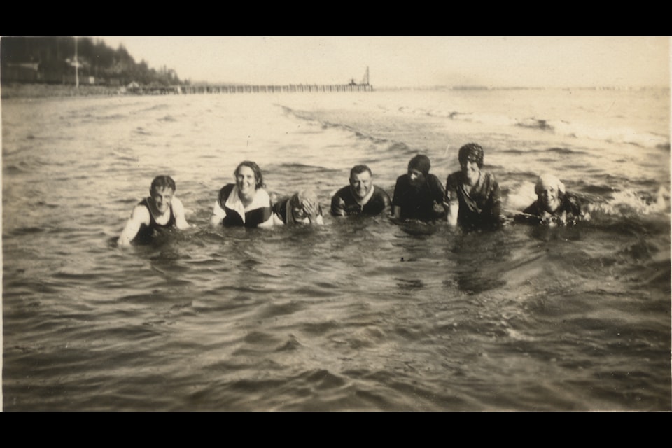 Swimmers enjoy the water c. 1914. In the background, White Rock’s new pier is halfway to completion.
