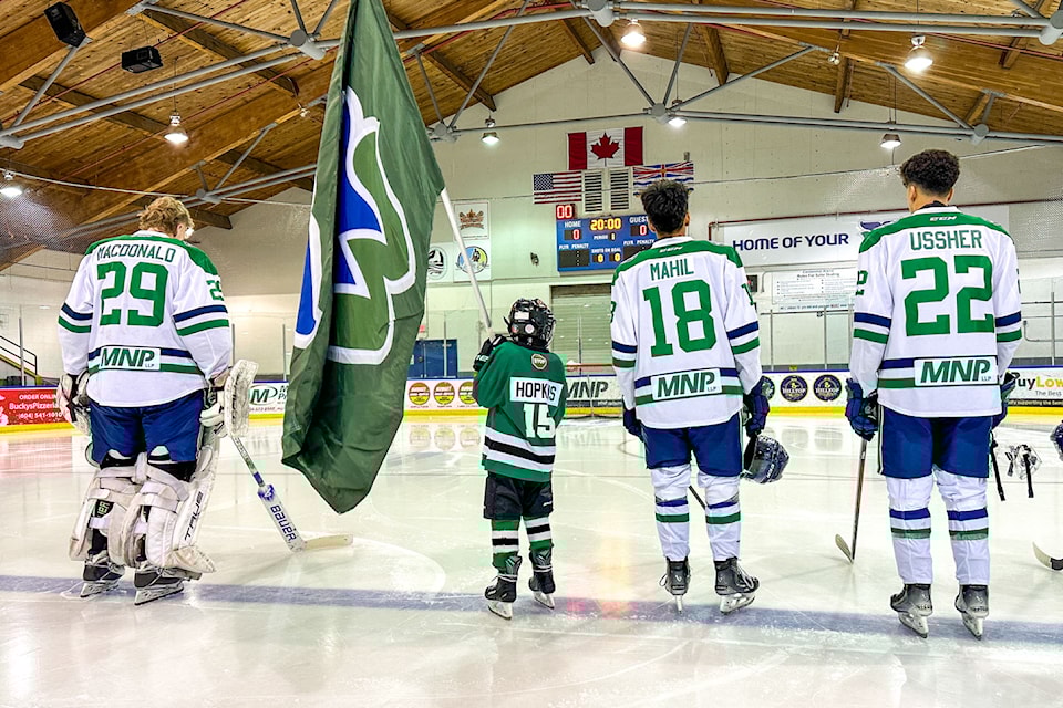 Flag bearer Hudson Hopkins from Semiahmoo Ravens U9 joined the Whalers' starting lineup before a game last season.