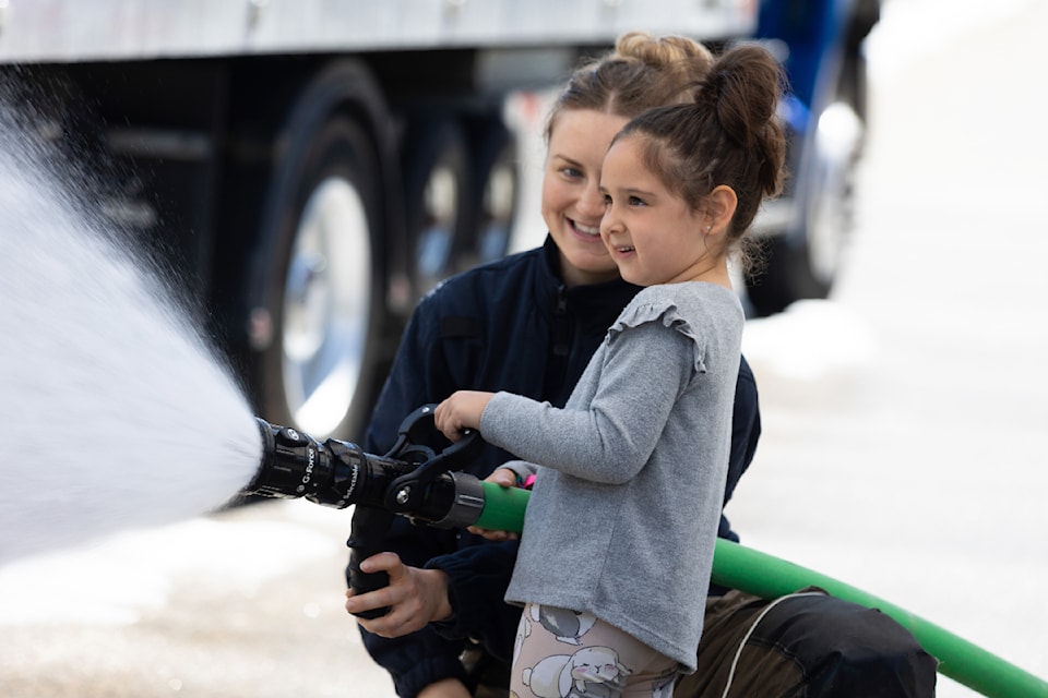 White Rock Fire Rescue and RCMP hold their annual open house May 10. Kiera Dhaliwal, 5, gets a helping hand trying out the fire hose at last year's open house event.