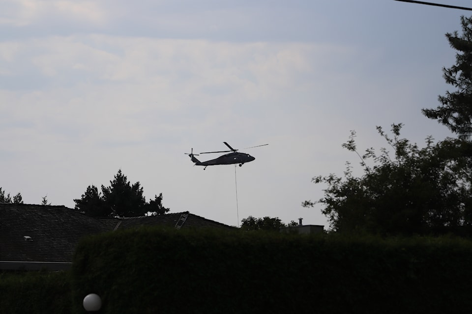 Fire crews tackled a brush fire off Marine Drive by helicopter on Sunday, Aug. 31 in White Rock, before being called to a house fire near Peace Arch Hospital.
